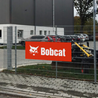 Bobcat bantex banner placed on the fence of dealership